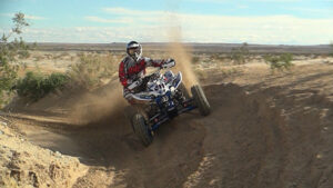 Honda 400EX powering through a deep sandy corner during testing.