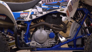 Right-side image of Honda400EX engine showing CT Racing head pipe and mid-range motor package.