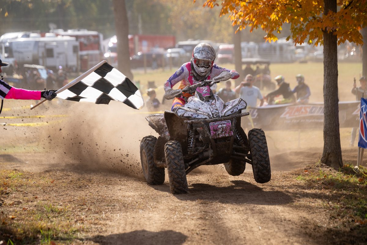 Brandon Frazier crosses the finish beside the checkered flag at the 2026 Ironman GNCC
