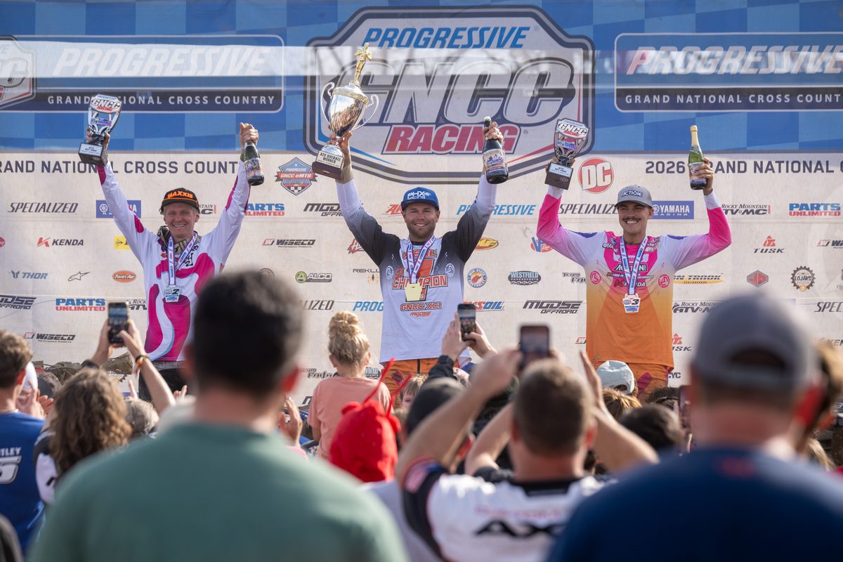 Brycen Neal, center, celebrates on the Ironman GNCC podium with Hunter Hart, left, and Wyatt Wilkin, right