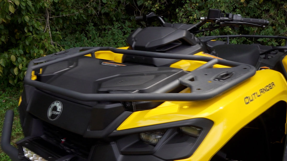 Three-quarter view of the Can-Am Outlander 700 highlighting the front rack and 9-gallon onboard storage box.