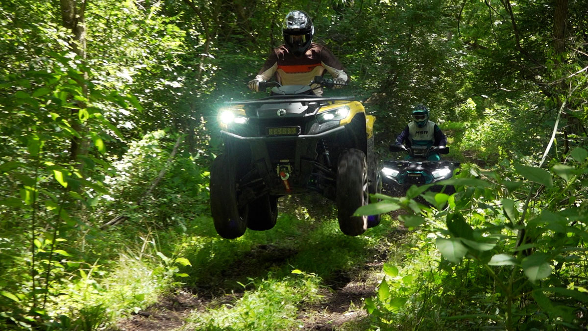 Can-Am Outlander 700 airborne over a jump, coming toward the camera.