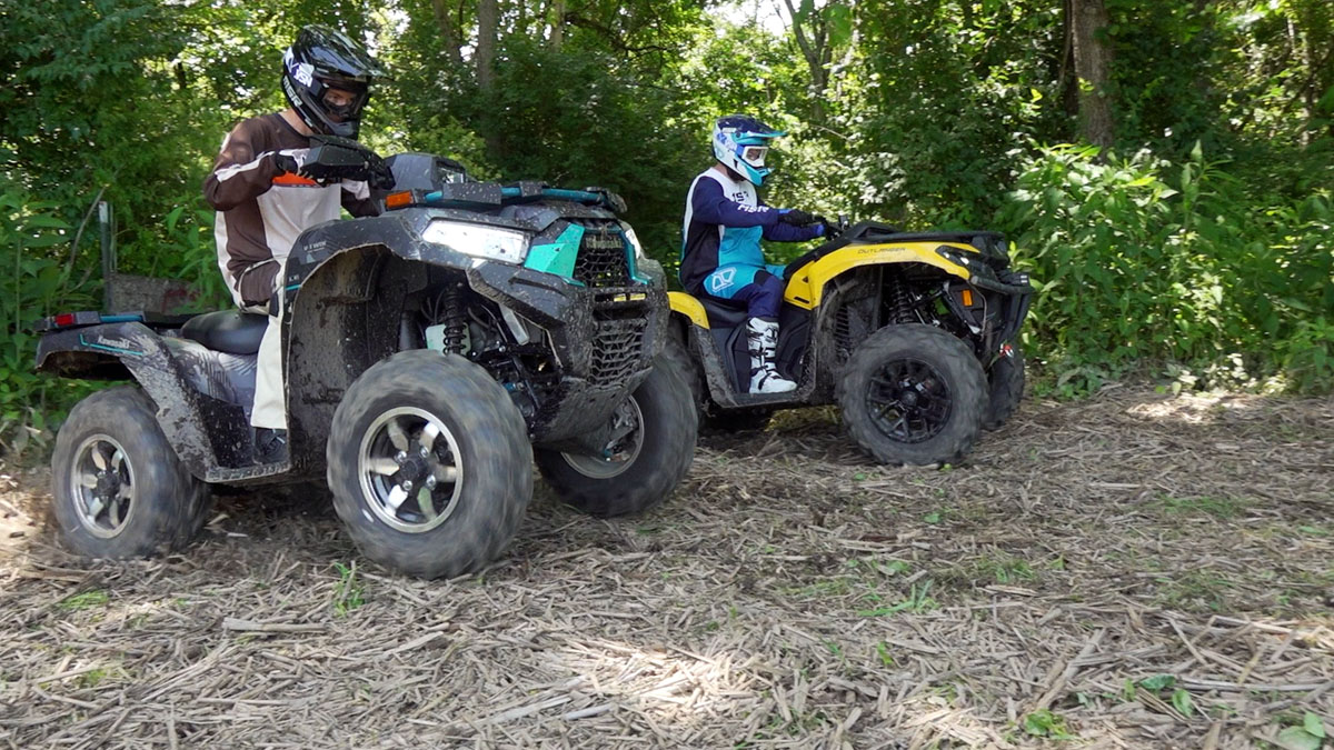 Checking.The Kawasaki Brute Force 750, closest to the camera, and Can-Am Outlander 700 launch side by side in our drag race, with the Can-Am getting a slight jump off the line.
