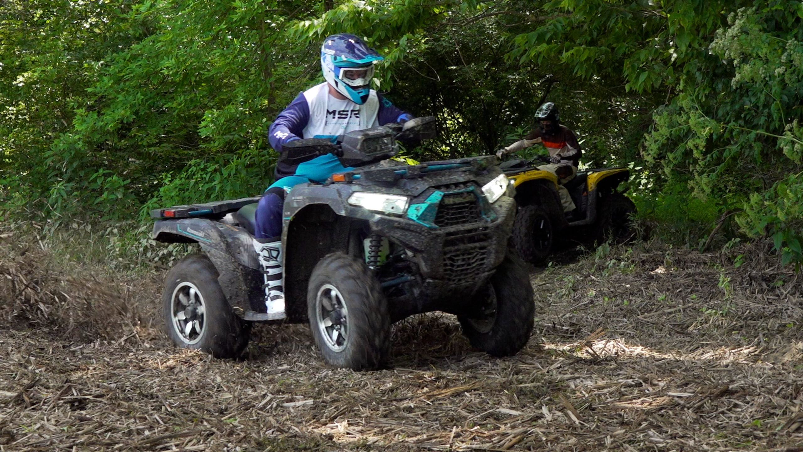 Brute Force charging into a corner, three-quarter front view, sliding through mulch.